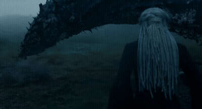 A Woman With Long Hair Is Standing Next To A Large Dragon GIF