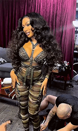 A Woman With Long Hair Is Standing Next To A Man In A Tattoo Studio . GIF