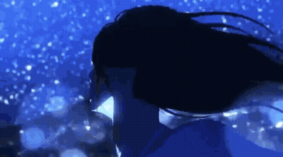 A Woman With Long Hair Is Swimming In The Water At Night . GIF