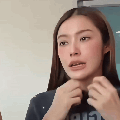 A Woman With Long Hair Is Wearing A Black Shirt That Says Air On It GIF