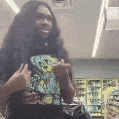 A Woman With Long Hair Is Wearing A Teddy Bear Shirt And Giving The Middle Finger GIF