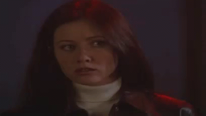 A Woman With Long Hair Is Wearing A Turtleneck And A Leather Jacket . GIF