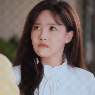 A Woman With Long Hair Is Wearing A White Shirt GIF