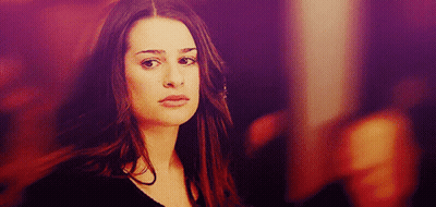 A Woman With Long Hair Looks At The Camera With A Purple Background GIF