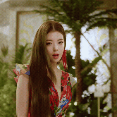 A Woman With Long Hair Wearing A Floral Dress GIF