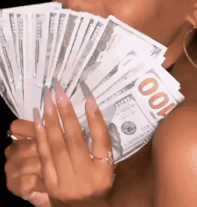 A Woman With Long Nails Is Holding A Bunch Of Money In Her Hands . GIF