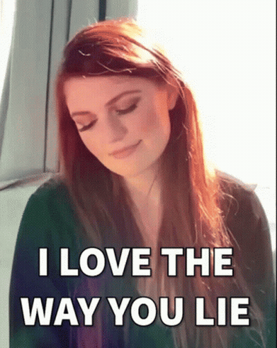 A Woman With Long Red Hair Is Smiling With The Words I Love The Way You Lie Below Her GIF