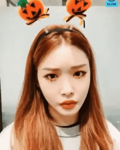 A Woman With Long Red Hair Wearing A Headband With Pumpkins On It . GIF