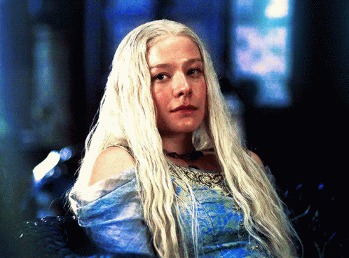A Woman With Long White Hair Is Wearing A Blue Top GIF