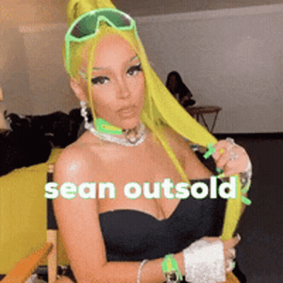 A Woman With Neon Green Hair Is Sitting In A Chair With The Words Sean Outsold On The Bottom GIF