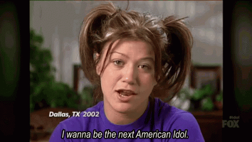 A Woman With Pigtails On Her Head Is Wearing A Purple Shirt And Says I Wanna Be The Next American Idol . GIF