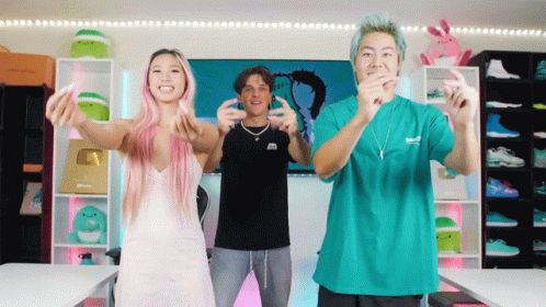 A Woman With Pink Hair And A Man In A Green Shirt Are Dancing GIF