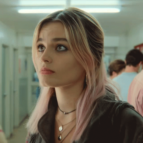 A Woman With Pink Hair And A Nose Ring GIF