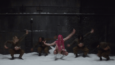A Woman With Pink Hair Is Dancing In Front Of A Group Of Dancers GIF