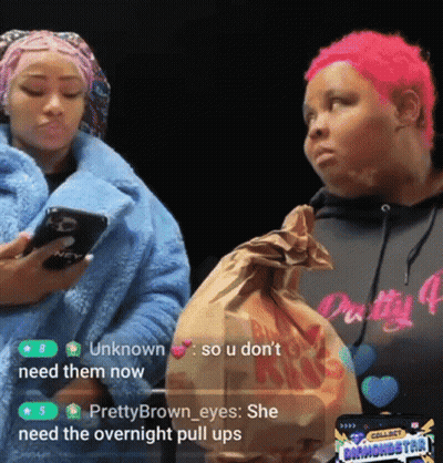 A Woman With Pink Hair Is Holding A Bag Of Food While Another Woman Looks On GIF