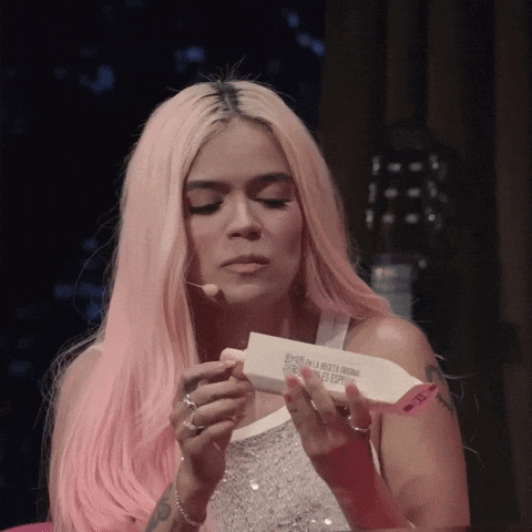 A Woman With Pink Hair Is Holding A Piece Of Paper That Says ' Esperanza En La Libertad Original ' On It GIF