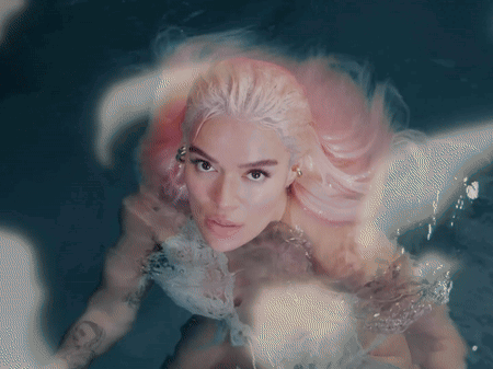 A Woman With Pink Hair Is In The Water GIF