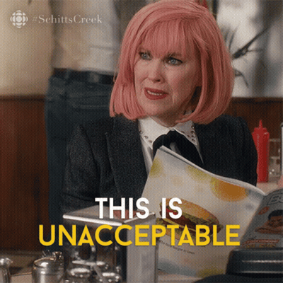 A Woman With Pink Hair Is Reading A Menu And Says This Is Unacceptable In Yellow Letters GIF