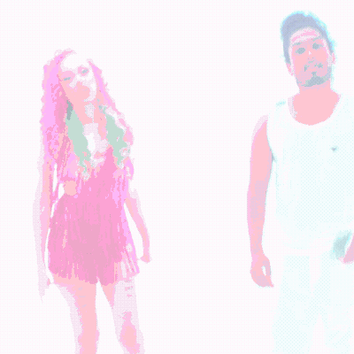 A Woman With Pink Hair Is Standing Next To A Man With White Pants GIF