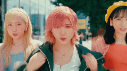 A Woman With Pink Hair Is Standing Next To Two Other Girls GIF