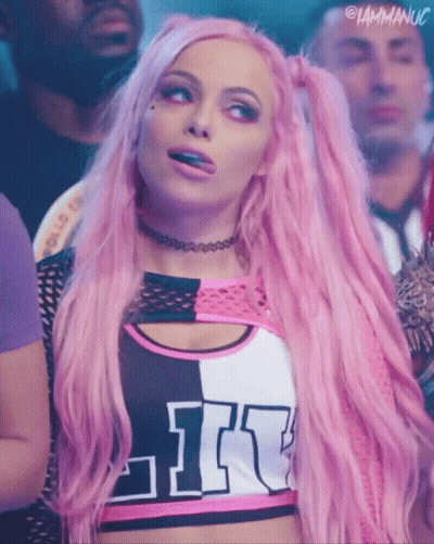 A Woman With Pink Hair Is Wearing A Top That Says Like On It GIF