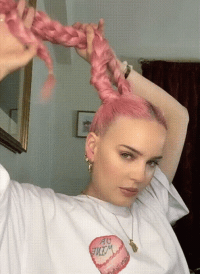 A Woman With Pink Hair Is Wearing A White T-Shirt That Has A Heart On It GIF