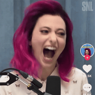 A Woman With Pink Hair Screaming Into A Microphone GIF