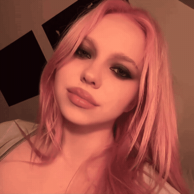 A Woman With Pink Hair Takes A Selfie With Her Eyes Closed GIF