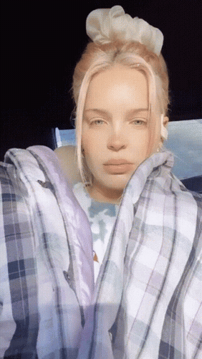A Woman With Pink Hair Wearing A Plaid Shirt GIF