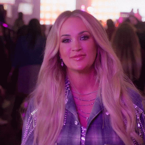 A Woman With Purple Hair And A Plaid Shirt Smiles For The Camera GIF