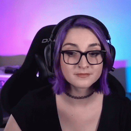 A Woman With Purple Hair And Glasses Is Wearing Headphones From Dxracer GIF