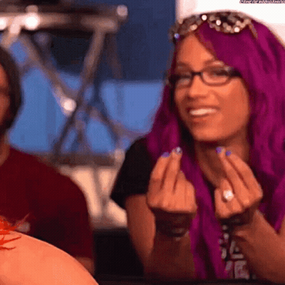 A Woman With Purple Hair Is Giving The Middle Finger . GIF