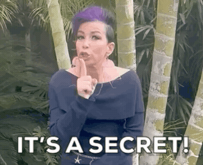 A Woman With Purple Hair Is Holding Her Finger To Her Lips And Says `` It 'S A Secret '' . GIF