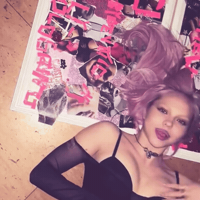 A Woman With Purple Hair Is Standing In Front Of A Poster That Says ' Ever After ' GIF