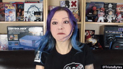 A Woman With Purple Hair Is Standing In Front Of A Shelf Full Of Video Games GIF