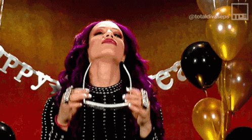 A Woman With Purple Hair Is Standing In Front Of Balloons With A Banner That Says Happy GIF