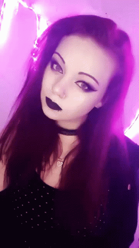 A Woman With Purple Hair Is Wearing A Choker And Black Lipstick GIF