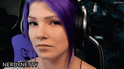 A Woman With Purple Hair Is Wearing Headphones And The Name Nerd Netty Is On The Bottom Right GIF