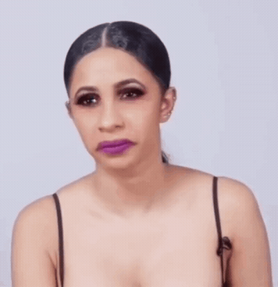 A Woman With Purple Lipstick On Her Lips And A Ponytail Is Making A Funny Face . GIF
