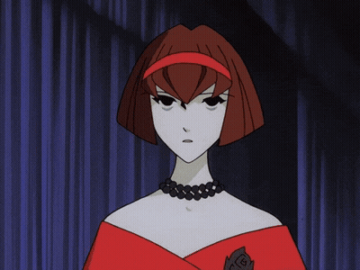 A Woman With Red Hair And A Black Necklace GIF