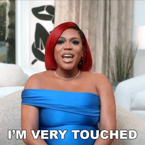 A Woman With Red Hair And A Blue Dress Says I 'M Very Touched GIF