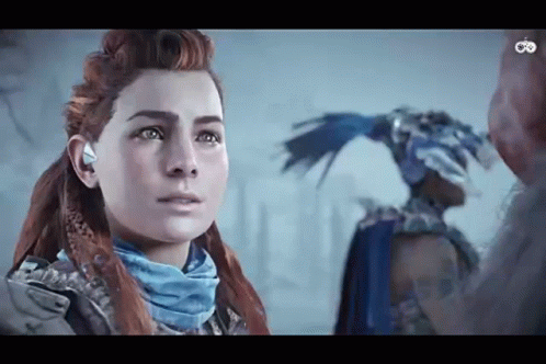 A Woman With Red Hair And A Blue Scarf Is Standing Next To A Man In A Blue Costume . GIF