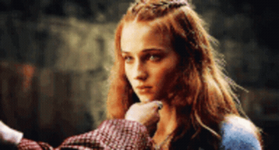 A Woman With Red Hair And A Crown On Her Head Is Being Touched By A Man 'S Hand . GIF