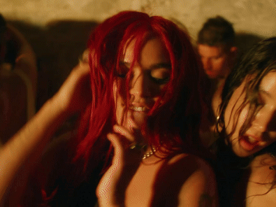 A Woman With Red Hair And A Necklace On Her Neck GIF