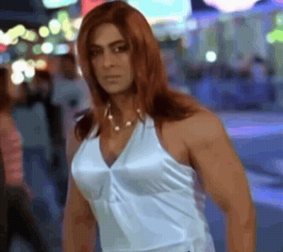 A Woman With Red Hair And A White Tank Top GIF