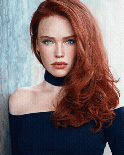 A Woman With Red Hair And Blue Eyes Is Wearing A Choker Around Her Neck GIF
