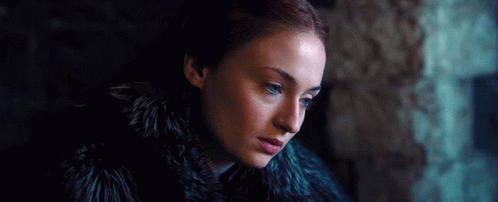 A Woman With Red Hair And Blue Eyes Is Wearing A Fur Coat . GIF