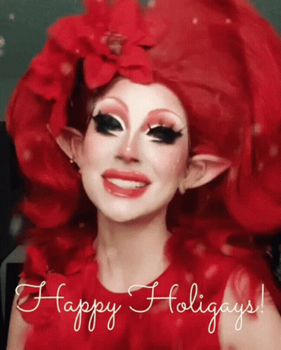 A Woman With Red Hair And Elf Ears Is Smiling With The Words Happy Holidays Below Her GIF