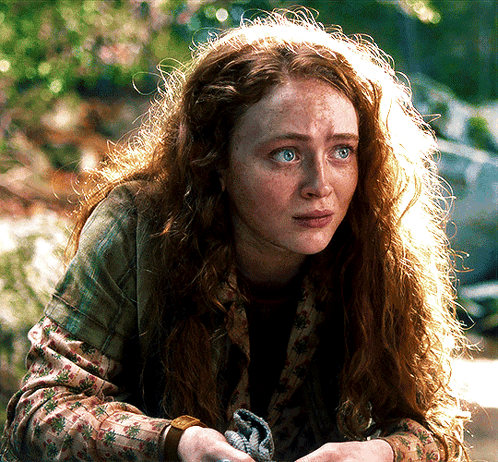 A Woman With Red Hair And Freckles Looks At The Camera With A Sad Look On Her Face GIF