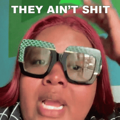A Woman With Red Hair And Glasses Is Making A Funny Face And Saying They Ain 'T Shit . GIF
